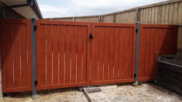 A red-stained double timber gate