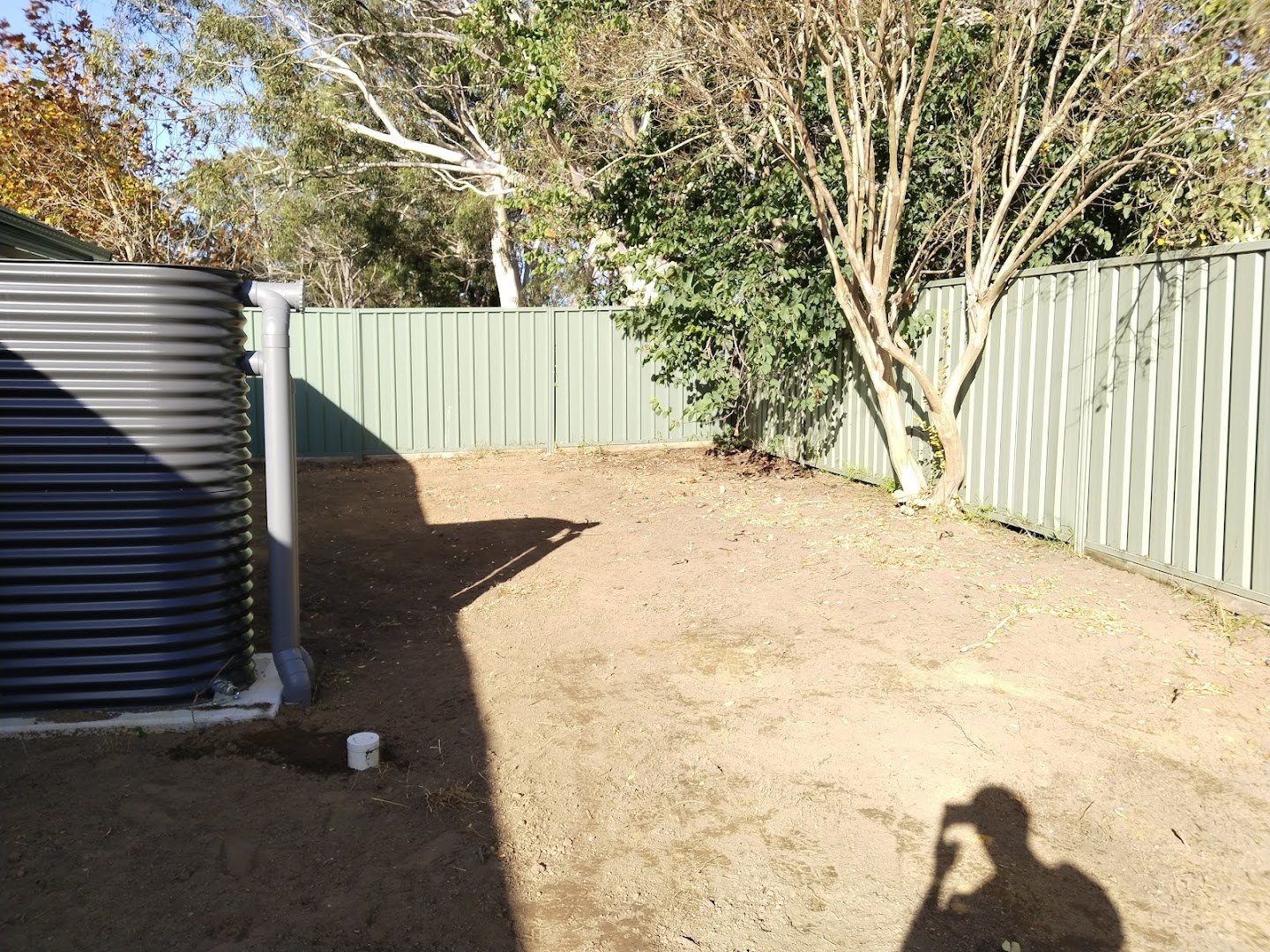 A cleared and levelled backyard with new fencing