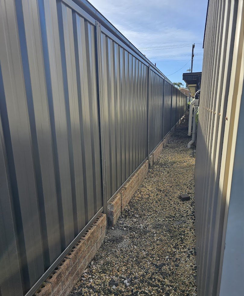 A narrow side access finished between two fences